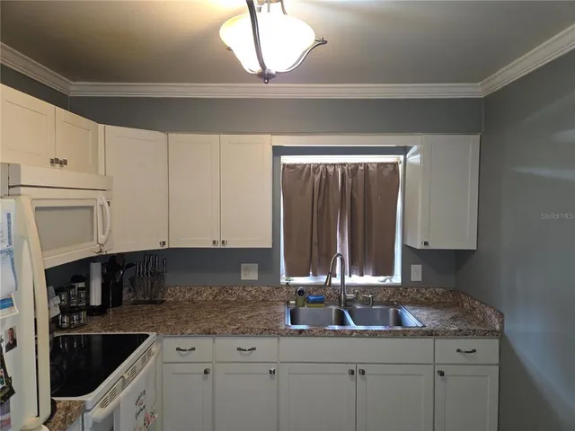 a kitchen with a sink and cabinets