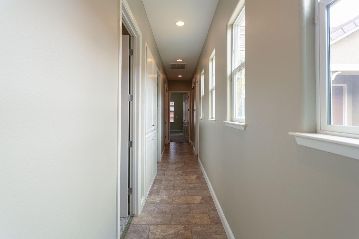 3271 Graybark Avenue Clovis, CA 93619 - Photo 19 of 26 a view of a hallway with wooden floor and staircase