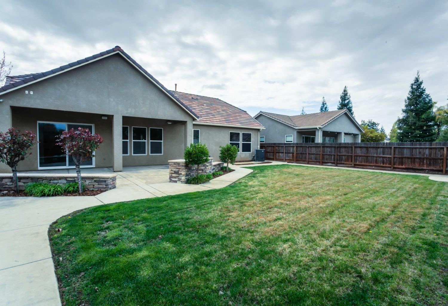 3271 Graybark Avenue Clovis, CA 93619 - Photo 21 of 26 a front view of a house with garden