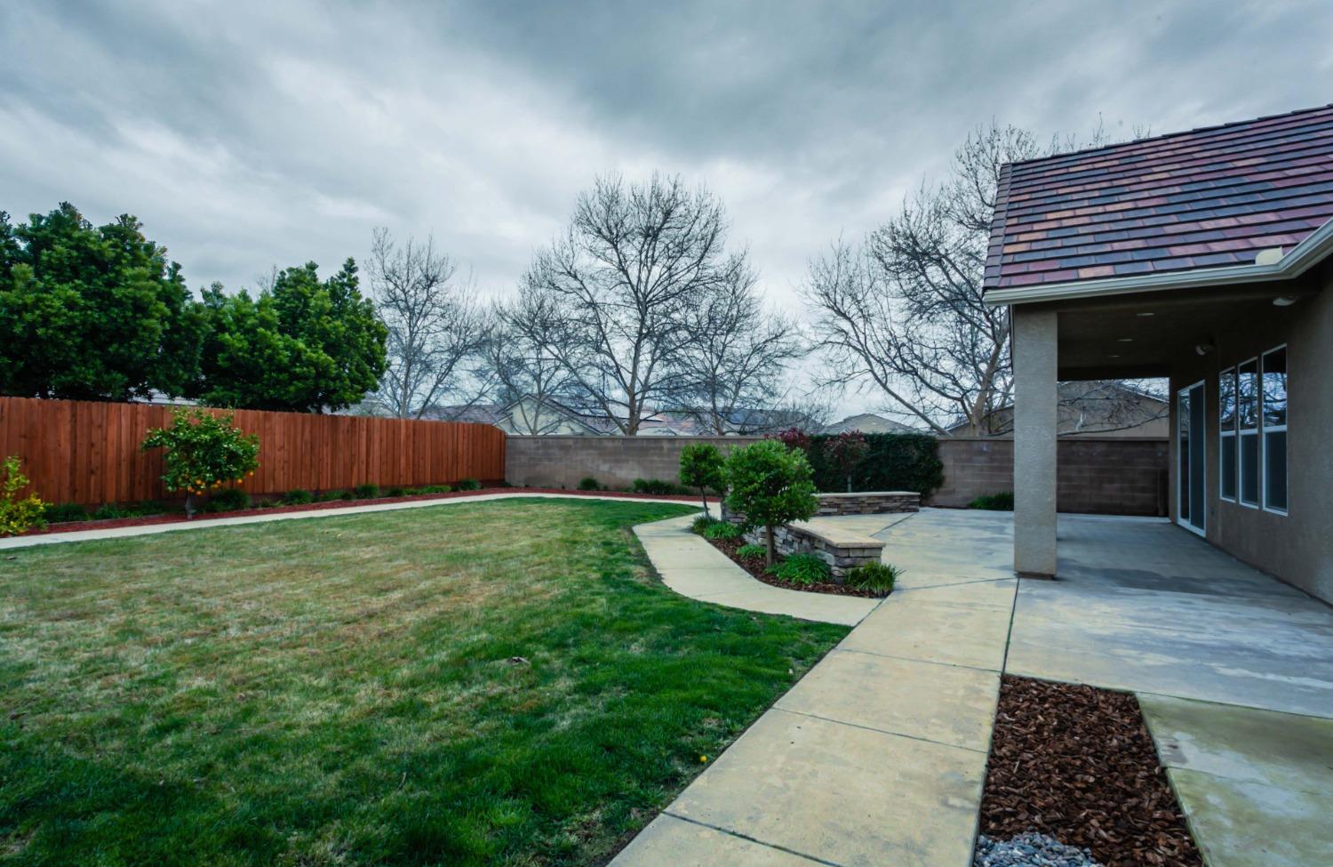 3271 Graybark Avenue Clovis, CA 93619 - Photo 22 of 26 a view of a patio with chair and tables