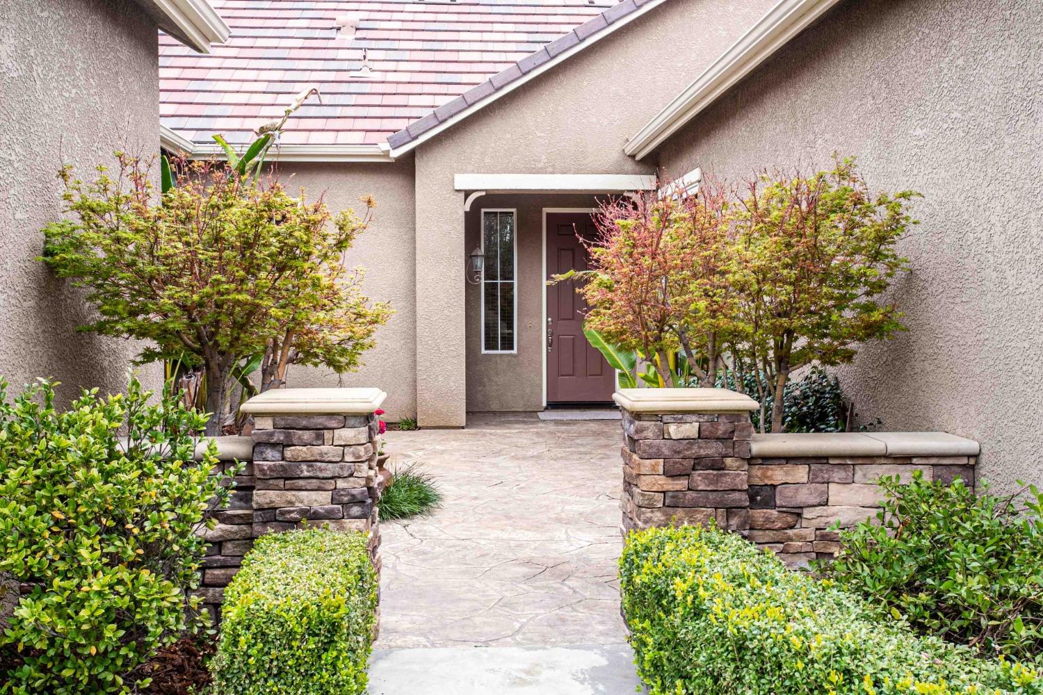 3271 Graybark Avenue Clovis, CA 93619 - Photo 3 of 26 a front view of a house with garden