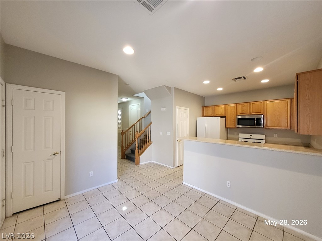 9843 West Overlook Ridge Avenue Las Vegas, NV 89148 - Photo 2 of 19 An inviting open-concept layout features a well-lit kitchen flowing into a spacious living area.