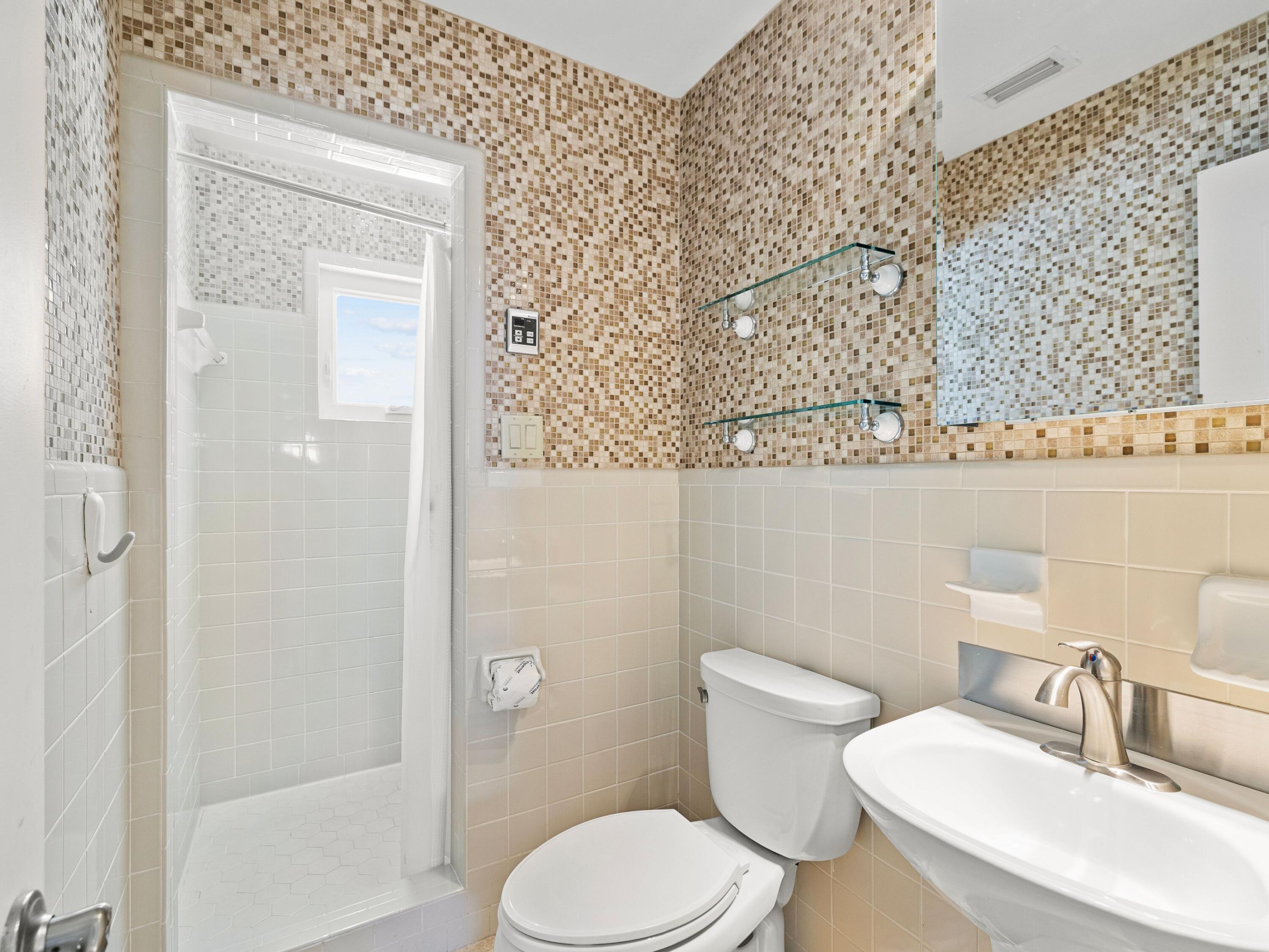 36 Green Street Inlet Beach, FL 32461 - Photo 11 of 27 a white toilet sitting next to a bathroom sink
