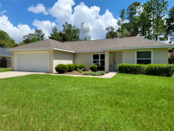 a front view of house with yard and green space