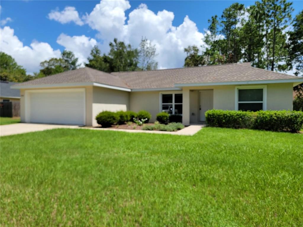 a front view of house with yard and green space