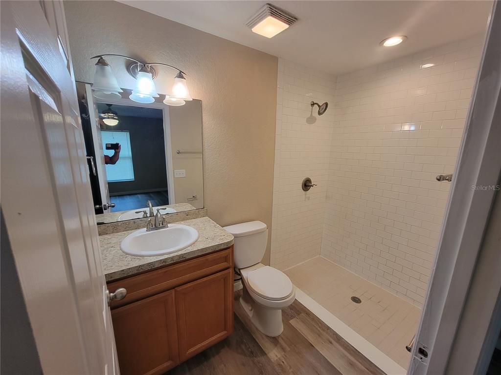 7009 Hemlock Road Ocala, FL 34472 - Photo 3 of 10 a bathroom with a sink a toilet and shower