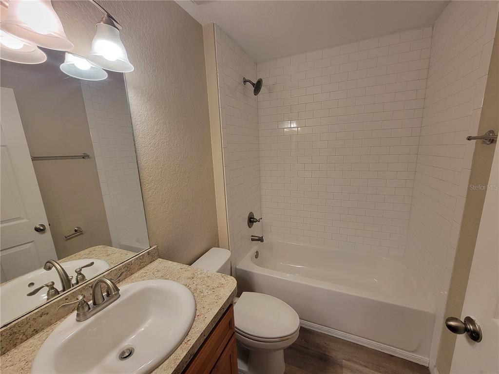 7009 Hemlock Road Ocala, FL 34472 - Photo 4 of 10 a bathroom with a sink toilet and shower