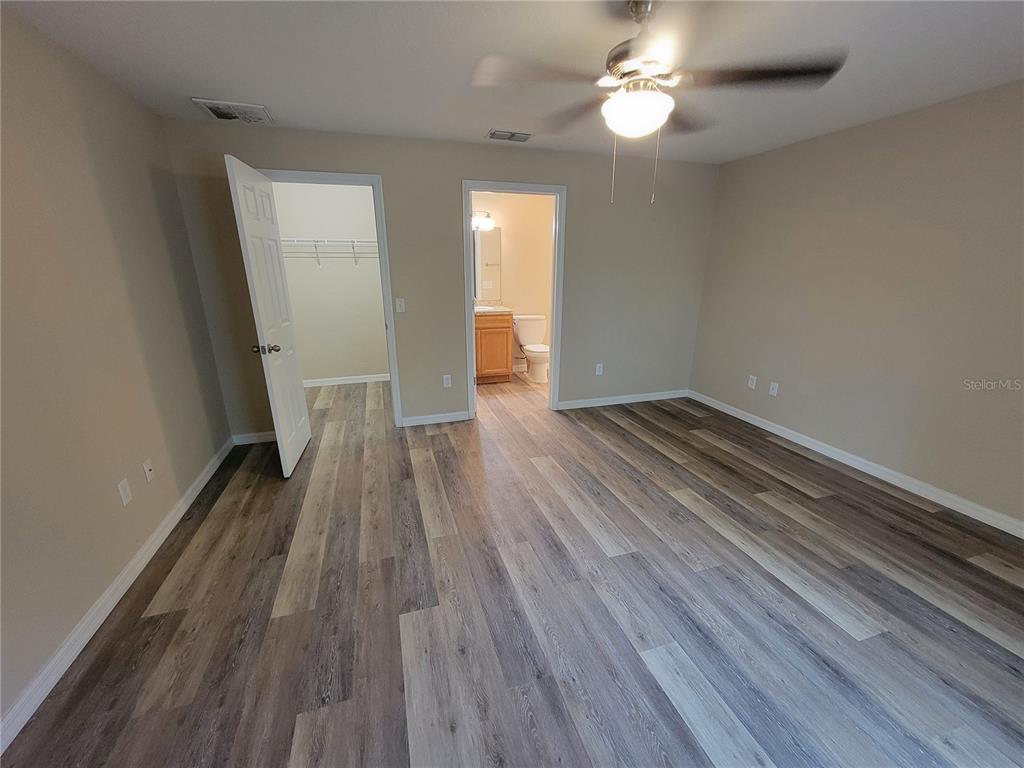 7009 Hemlock Road Ocala, FL 34472 - Photo 6 of 10 wooden floor in an empty room with a mirror