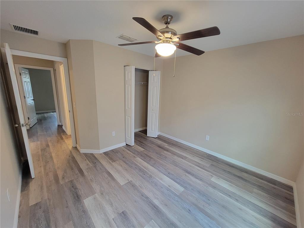 7009 Hemlock Road Ocala, FL 34472 - Photo 8 of 10 wooden floor in an empty room with a mirror
