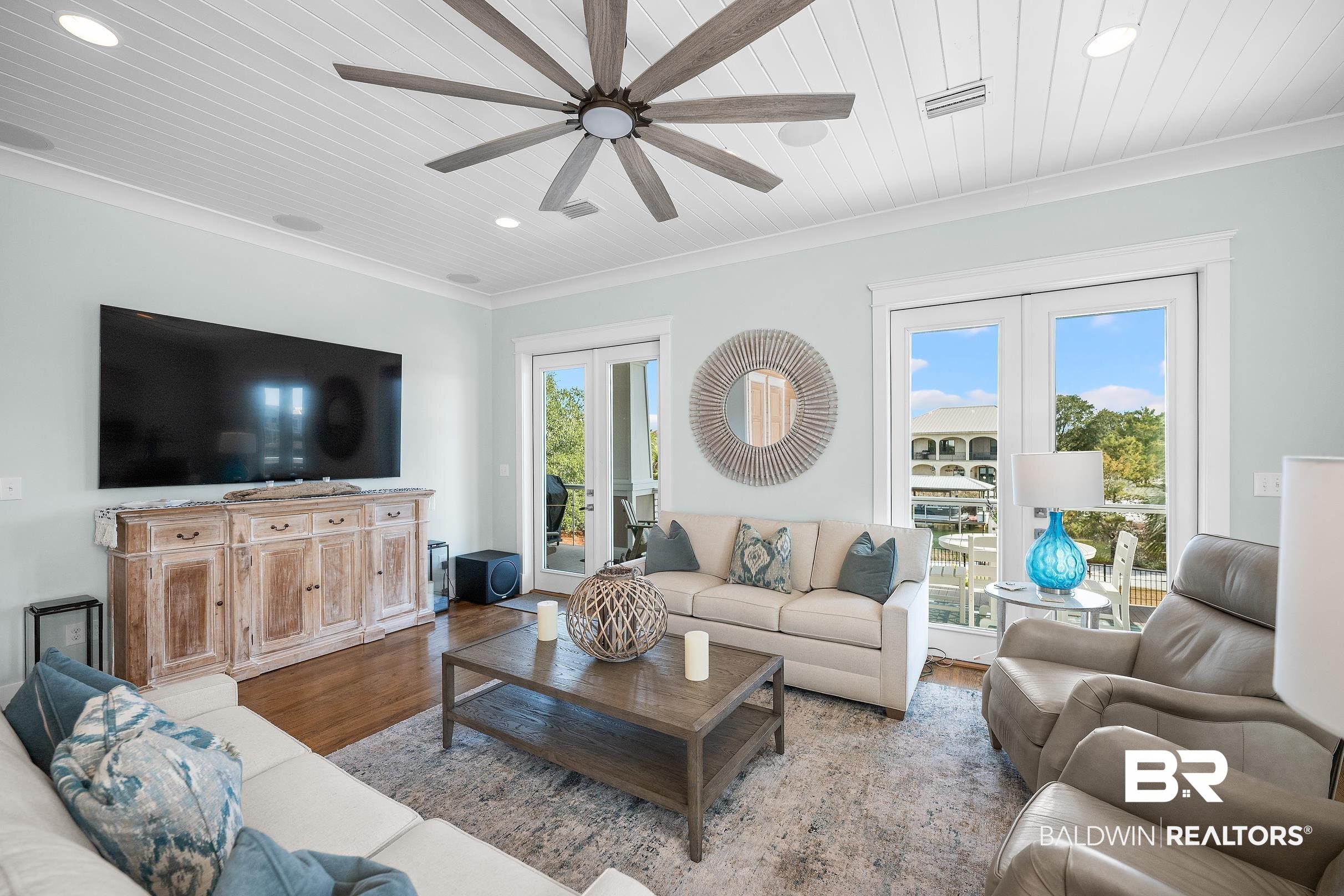 33186 Marlin Key Drive Orange Beach, AL 36561 - Photo 43 of 87 Living area featuring french doors, wood finished floors, crown molding, ceiling fan, and recessed lighting