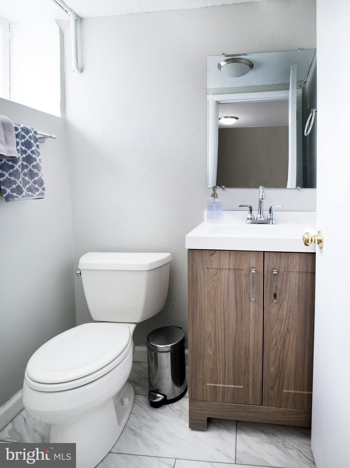 123 Old Forest Road Wynnewood, PA 19096 - Photo 23 of 29 a bathroom with a toilet a sink and mirror