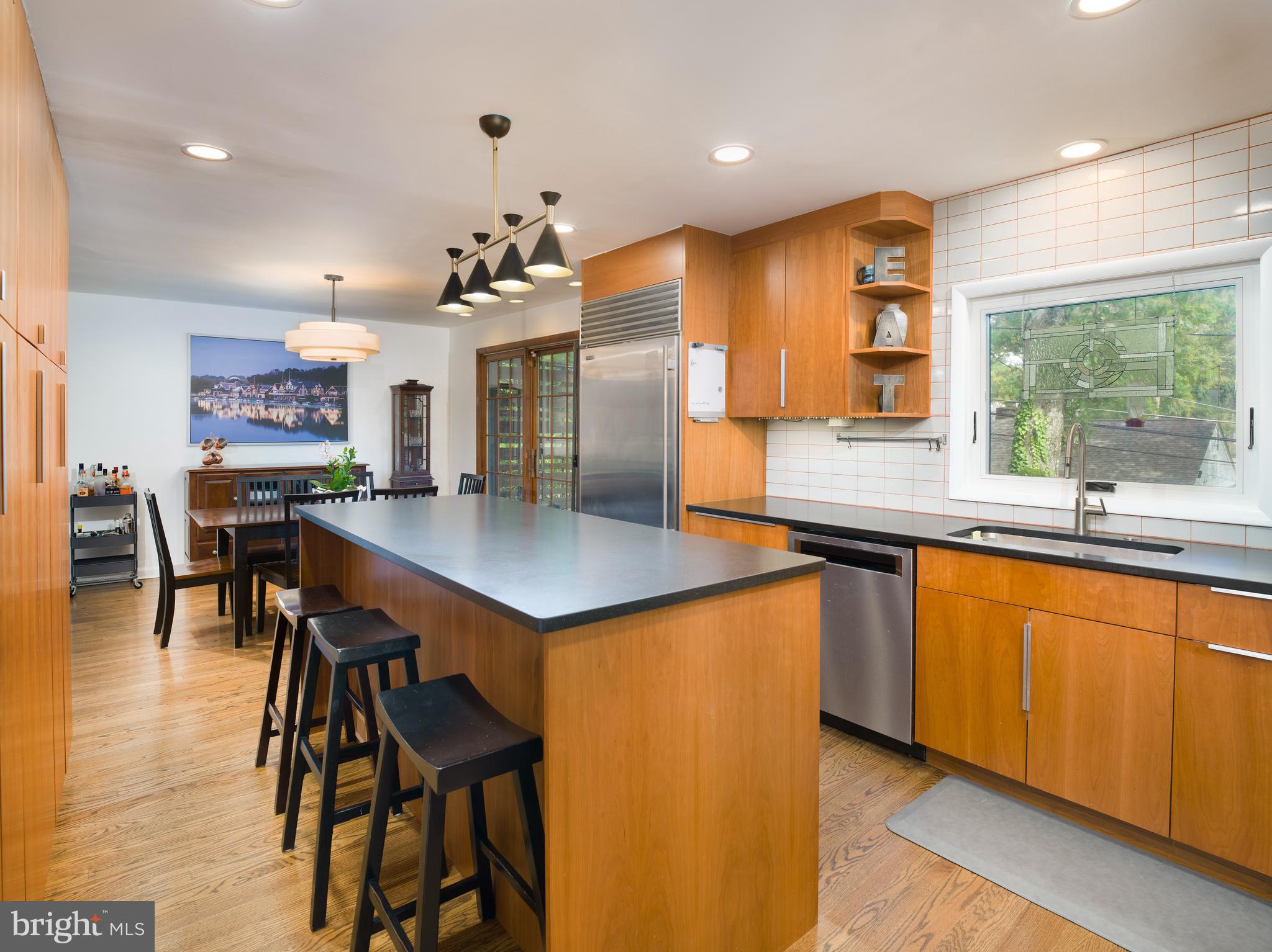 123 Old Forest Road Wynnewood, PA 19096 - Photo 9 of 29 a kitchen with stainless steel appliances kitchen island wooden cabinets and dining table
