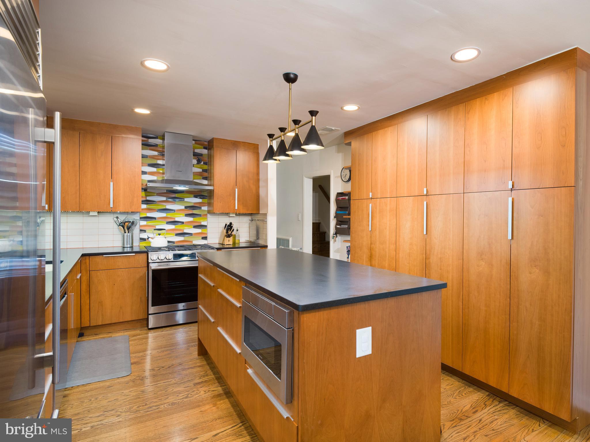 123 Old Forest Road Wynnewood, PA 19096 - Photo 10 of 29 a kitchen with stainless steel appliances granite countertop a sink a stove top oven a counter space and cabinets
