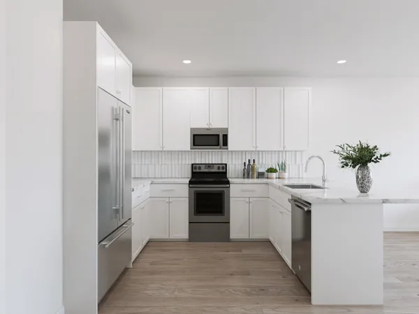 a kitchen with white cabinets and stainless steel appliances