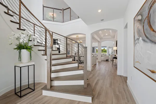 a kitchen with stainless steel appliances granite countertop a sink a stove and a wooden floors