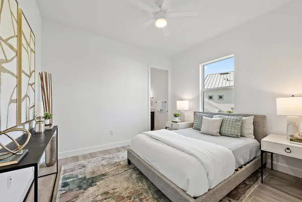 a spacious bedroom with a bed and a chandelier