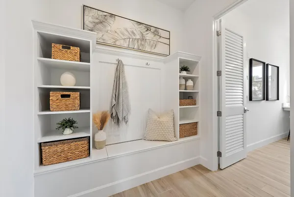 a view of empty room with wooden floor and windows