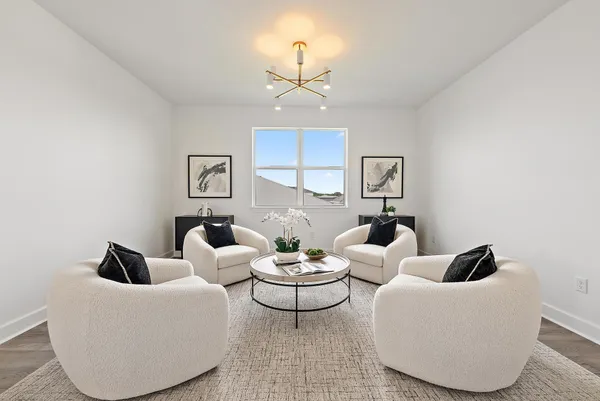 a living room with furniture and a floor to ceiling window