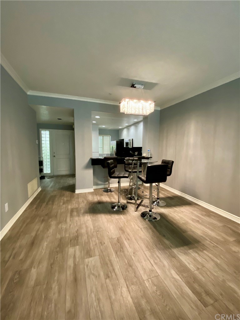 2233 Martin, Unit 108 Irvine, CA 92612 - Photo 3 of 30 Living room/Dining room with Detailed Crown Molding