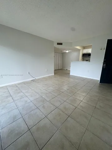 a view of an empty room and a window
