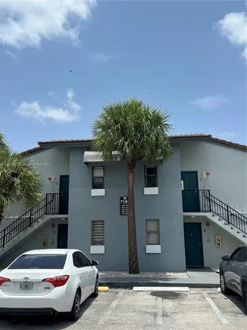 a view of a patio with couches and potted plants