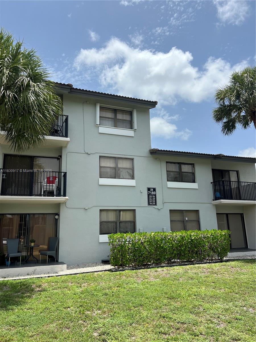 7180 Northwest 179th Street, Unit 109 Hialeah, FL 33015 - Photo 17 of 17 a front view of a house with a yard and garage