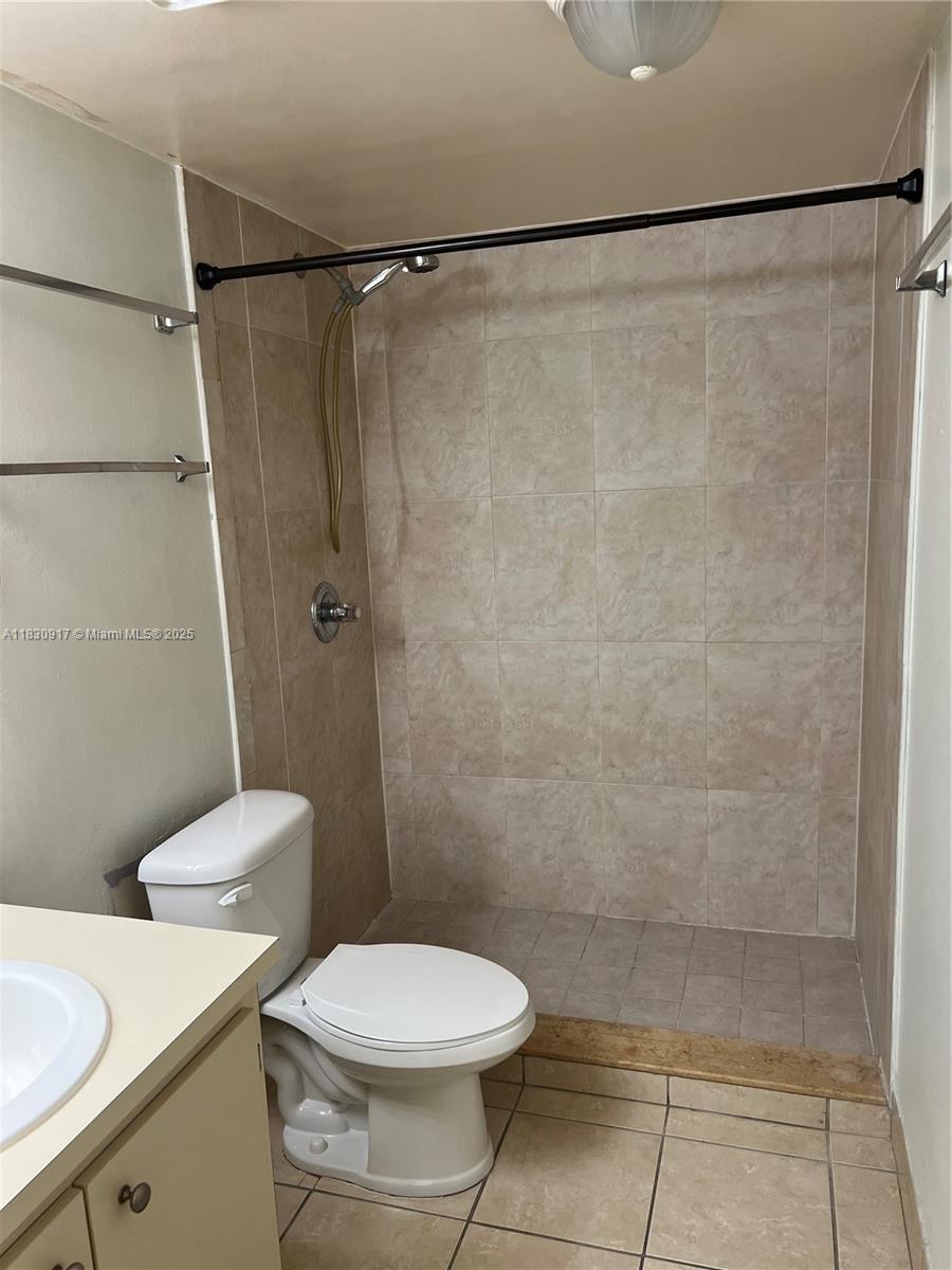 7180 Northwest 179th Street, Unit 109 Hialeah, FL 33015 - Photo 3 of 17 a bathroom with a toilet and a shower