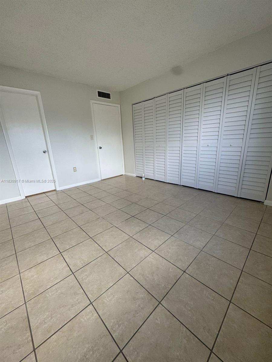 7180 Northwest 179th Street, Unit 109 Hialeah, FL 33015 - Photo 4 of 17 a view of an empty room