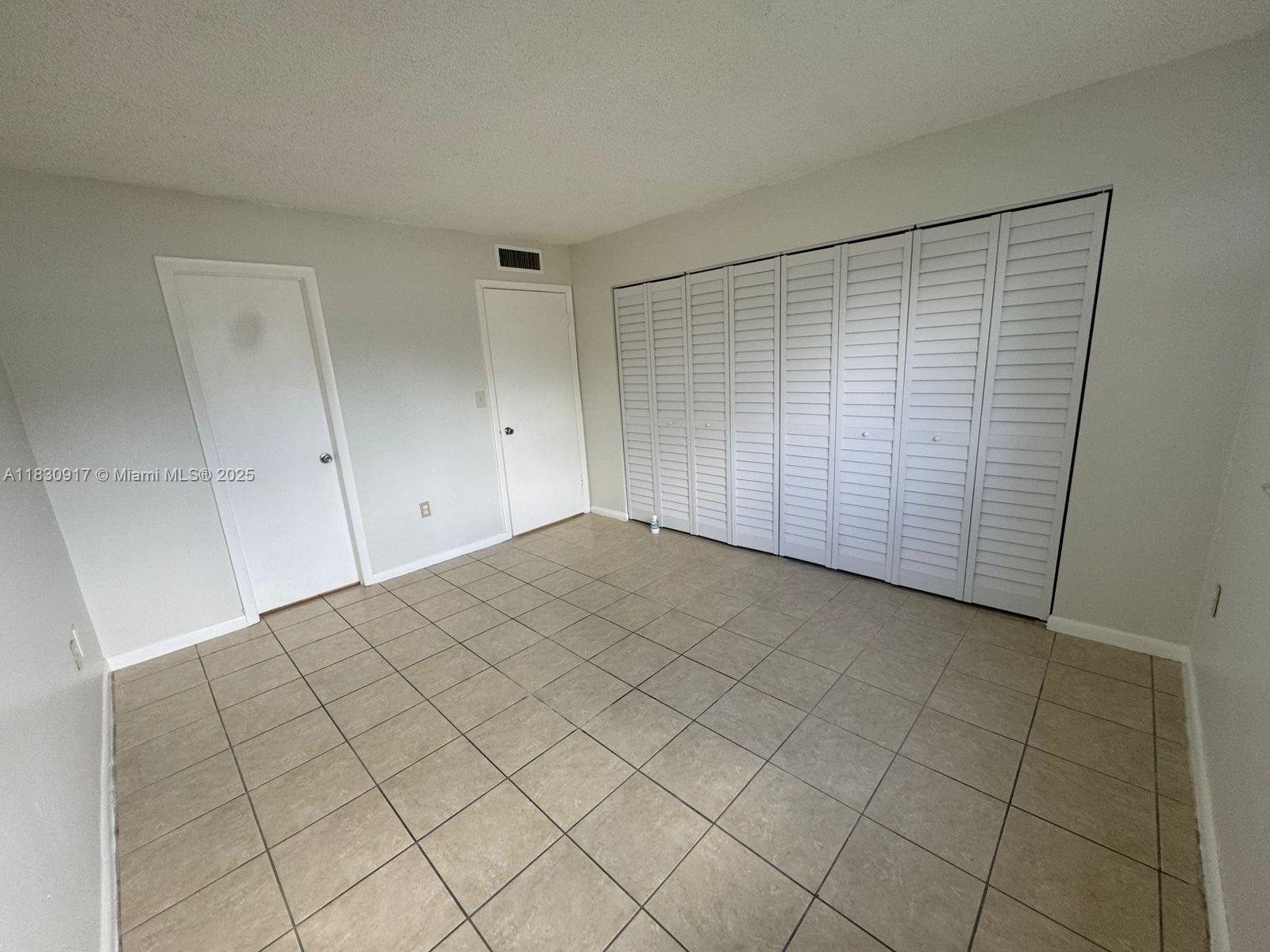 7180 Northwest 179th Street, Unit 109 Hialeah, FL 33015 - Photo 7 of 17 a view of empty room