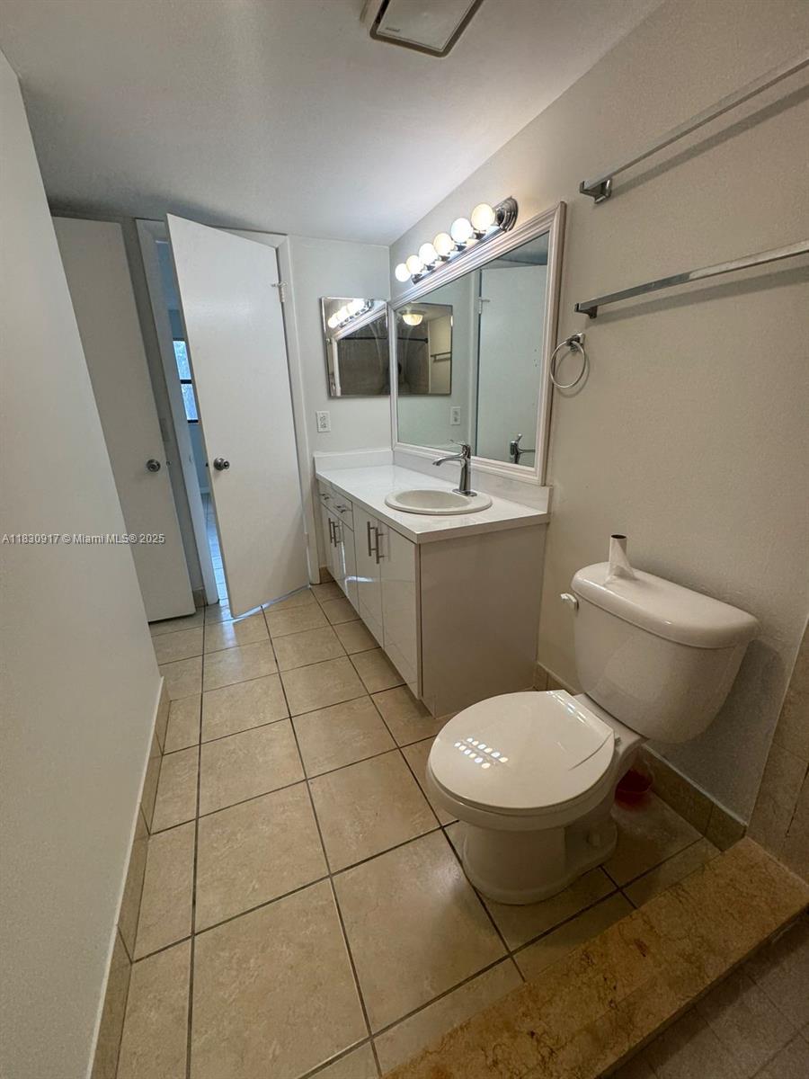 7180 Northwest 179th Street, Unit 109 Hialeah, FL 33015 - Photo 9 of 17 a bathroom with a sink toilet and shower