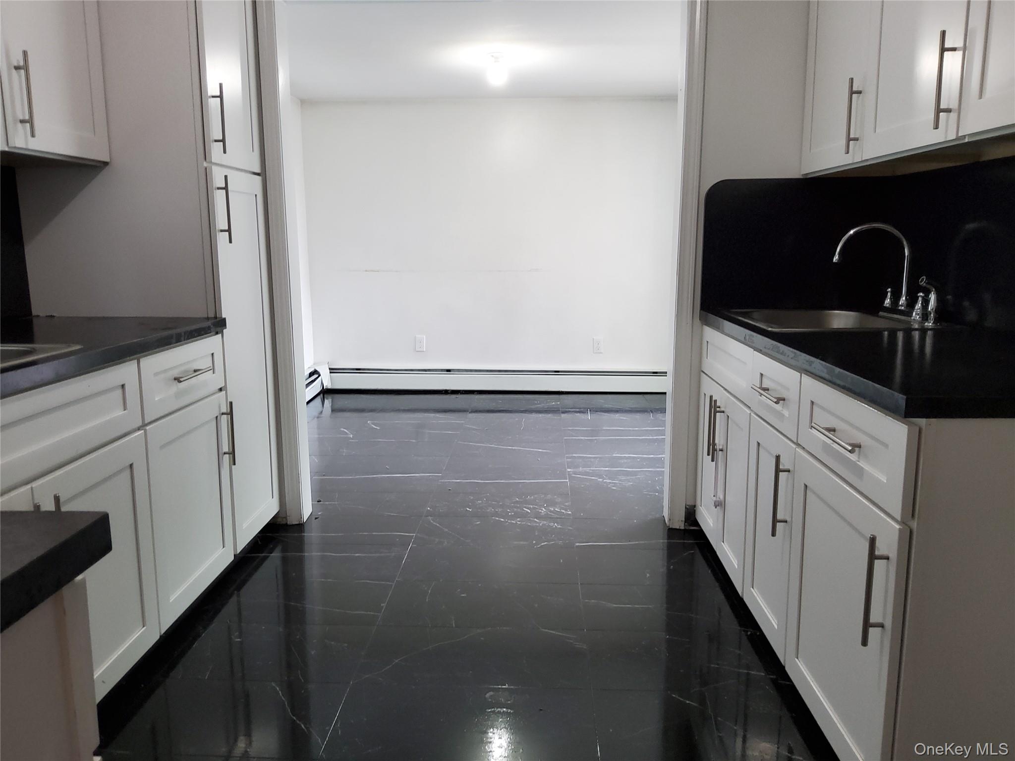 469 Hillside Road Monroe, NY 10950 - Photo 4 of 20 a kitchen with granite countertop white cabinets and black appliances