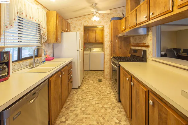 a view of a kitchen with a sink and cabinets