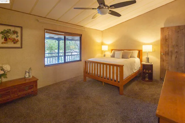 a bedroom with a bed lamp and a window