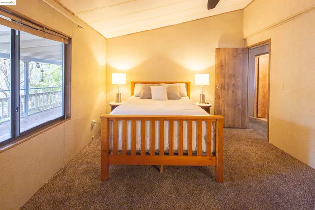 a bedroom with a bed and window