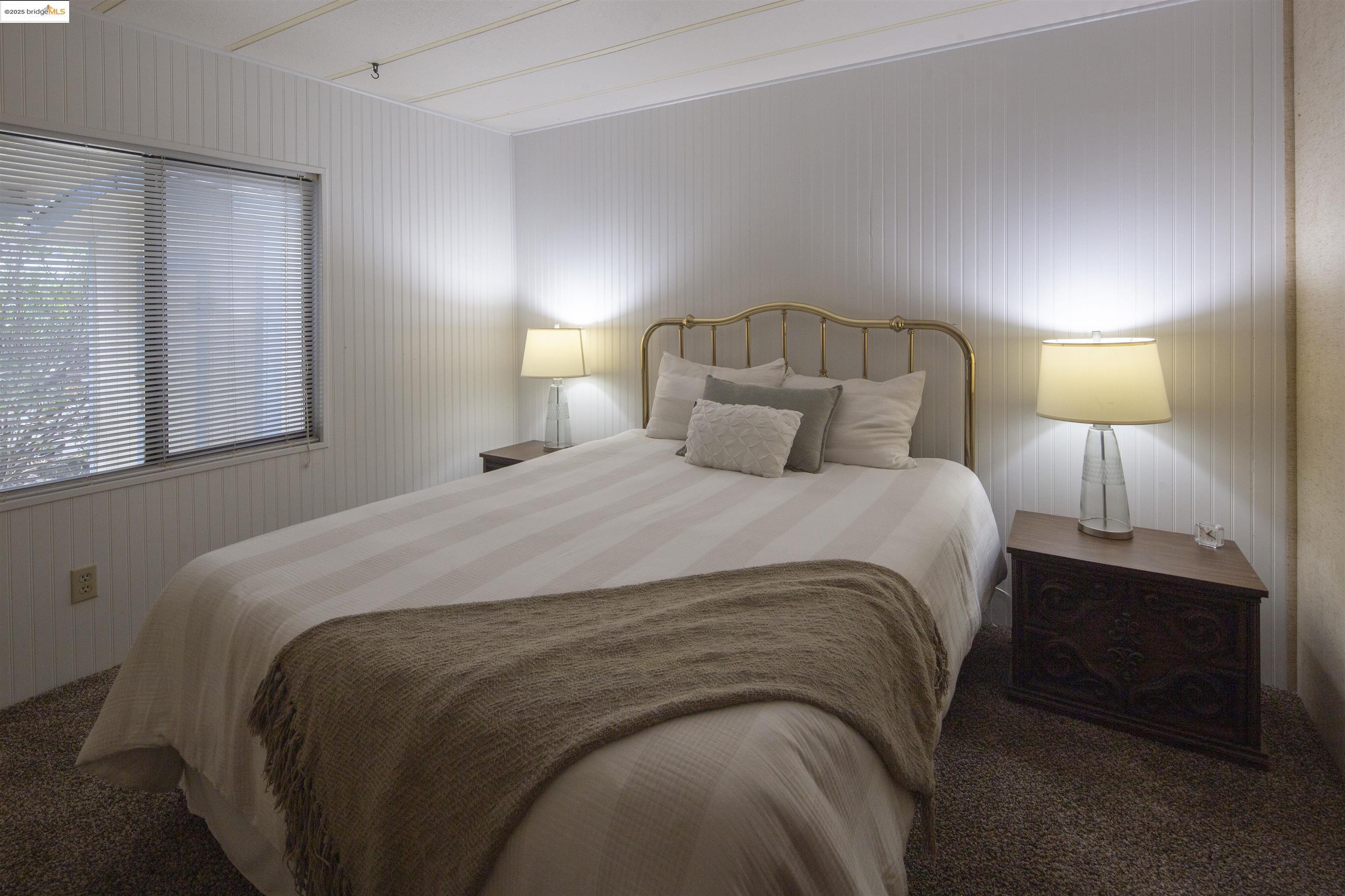 18717 Mill Villa Road, Unit 156 Jamestown, CA 95327 - Photo 18 of 40 Carpeted bedroom with wood walls