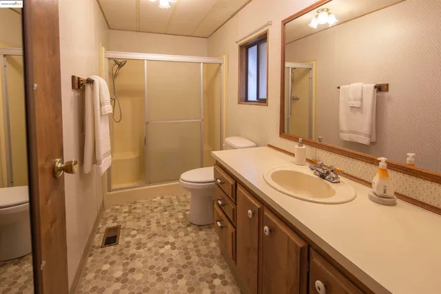 a bathroom with a sink toilet and shower