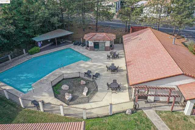 an aerial view of a house with outdoor space patio and furniture
