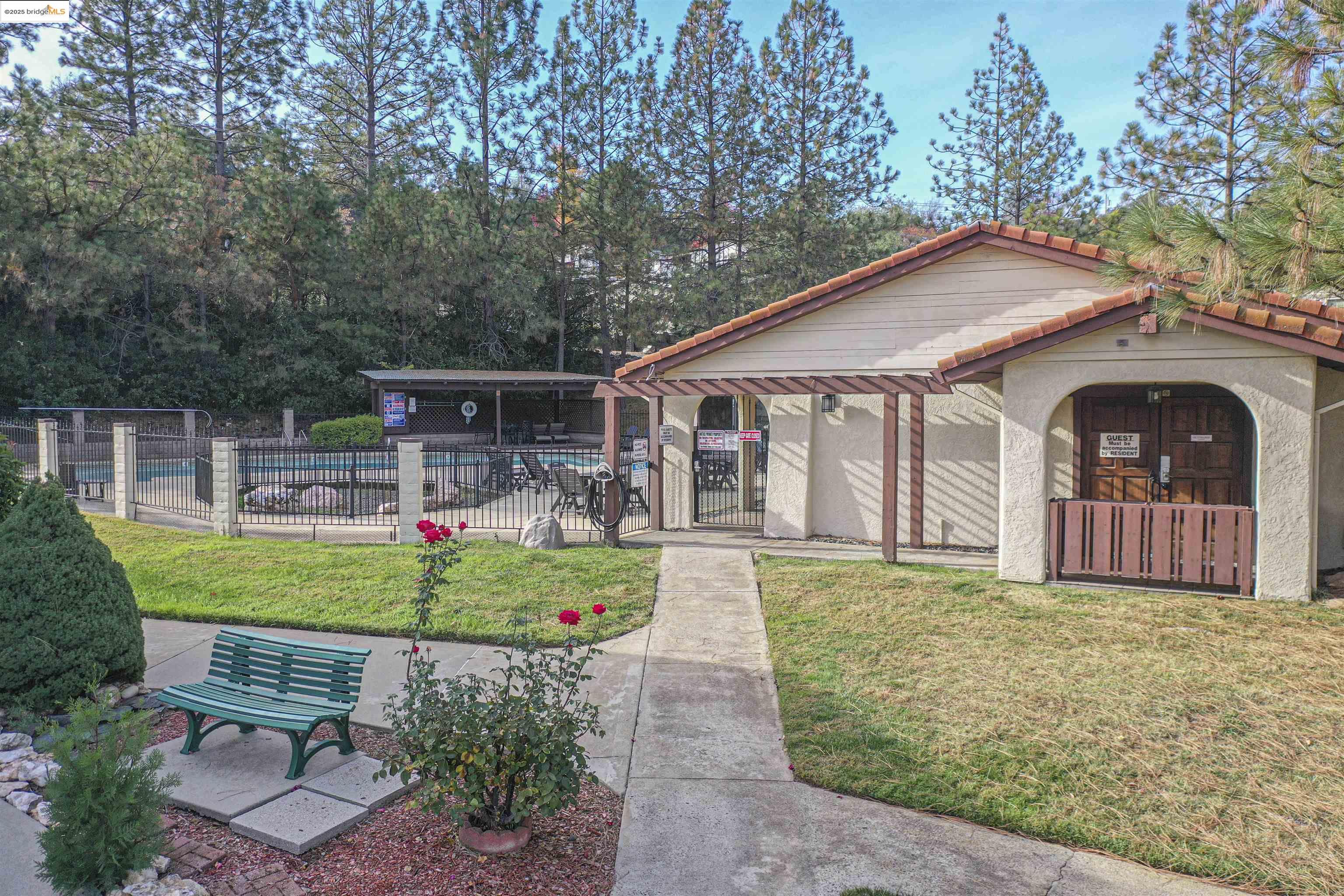 18717 Mill Villa Road, Unit 156 Jamestown, CA 95327 - Photo 29 of 40 Rear view of property with a community pool, stucco siding, a tile roof, a porch, and view of scattered trees