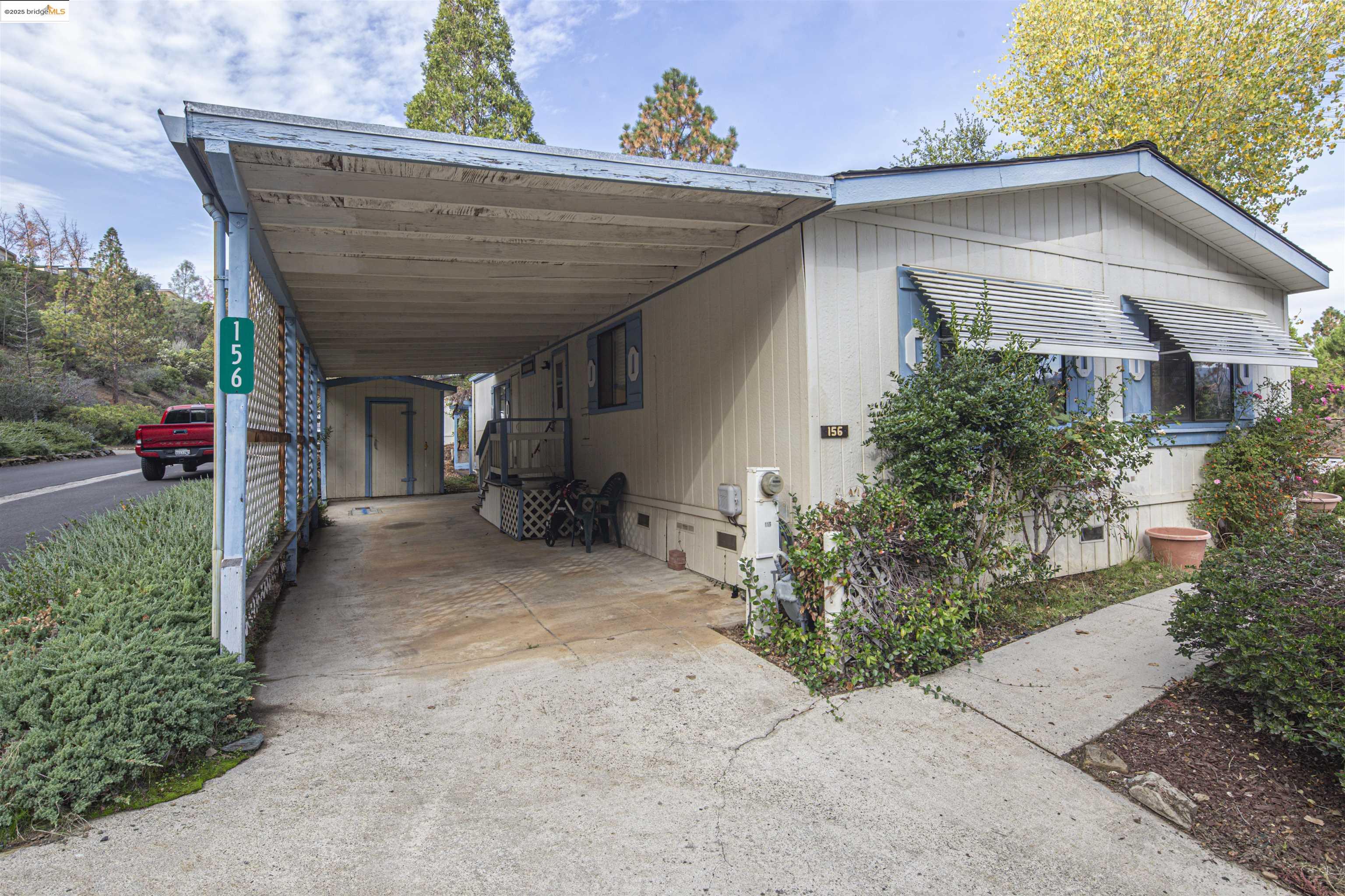 18717 Mill Villa Road, Unit 156 Jamestown, CA 95327 - Photo 31 of 40 View of parking featuring driveway and an attached carport