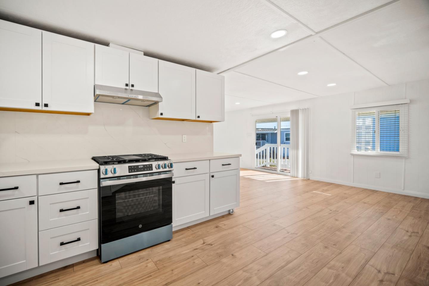 55 San Juan Grade Road, Unit 63 Salinas, CA 93906 - Photo 23 of 37 a kitchen with granite countertop a stove and a sink
