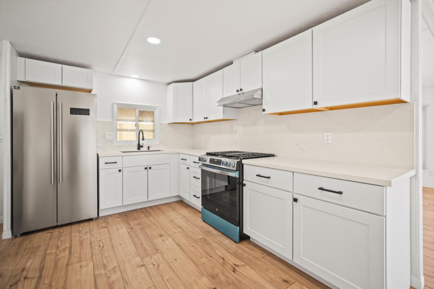 55 San Juan Grade Road, Unit 63 Salinas, CA 93906 - Photo 25 of 37 a kitchen with white cabinets and stainless steel appliances