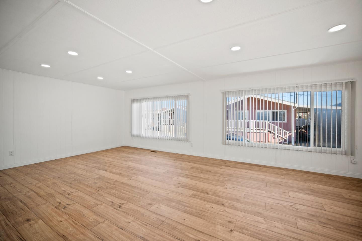 55 San Juan Grade Road, Unit 63 Salinas, CA 93906 - Photo 28 of 37 a view of an empty room with wooden floor and a window