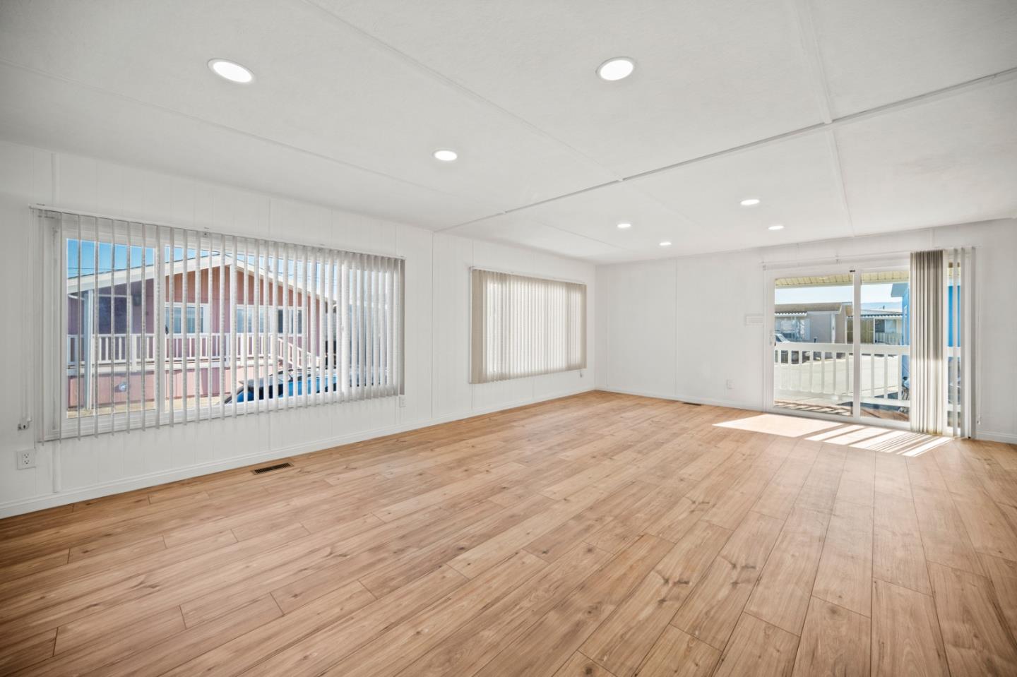 55 San Juan Grade Road, Unit 63 Salinas, CA 93906 - Photo 29 of 37 a view of an empty room with wooden floor and a window