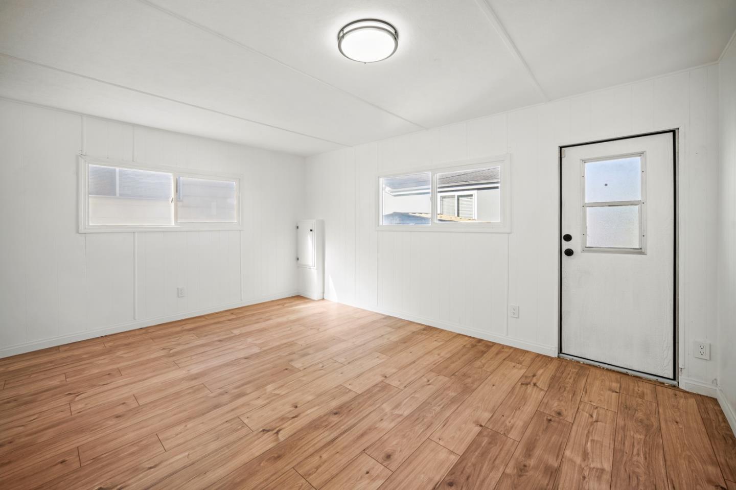 55 San Juan Grade Road, Unit 63 Salinas, CA 93906 - Photo 32 of 37 an empty room with wooden floor and windows