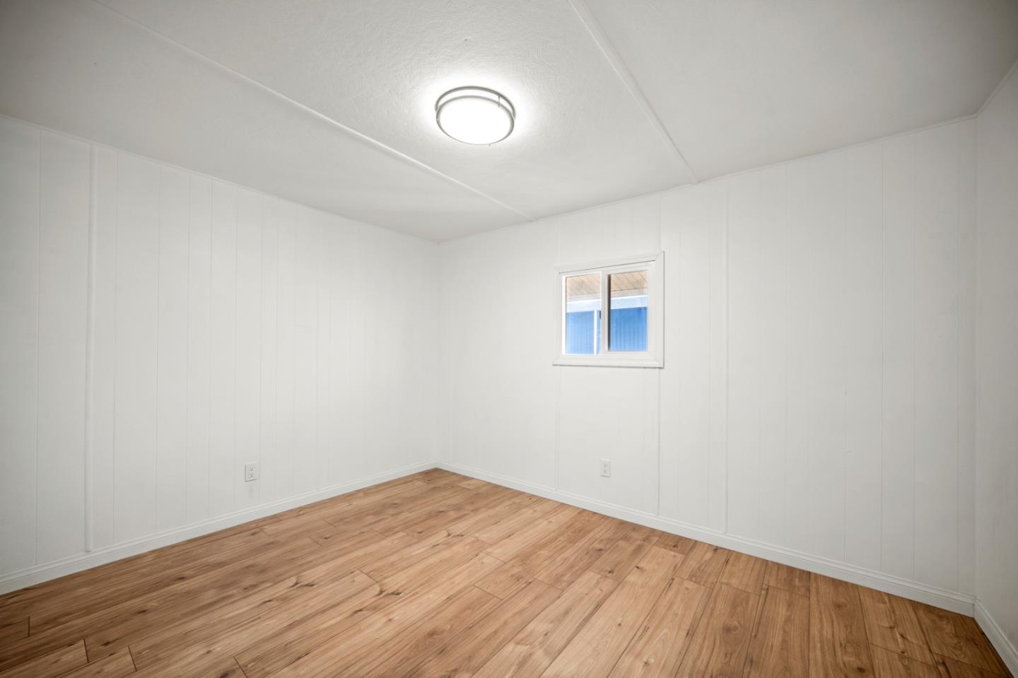 55 San Juan Grade Road, Unit 63 Salinas, CA 93906 - Photo 34 of 37 a view of a room with wooden floor and white walls