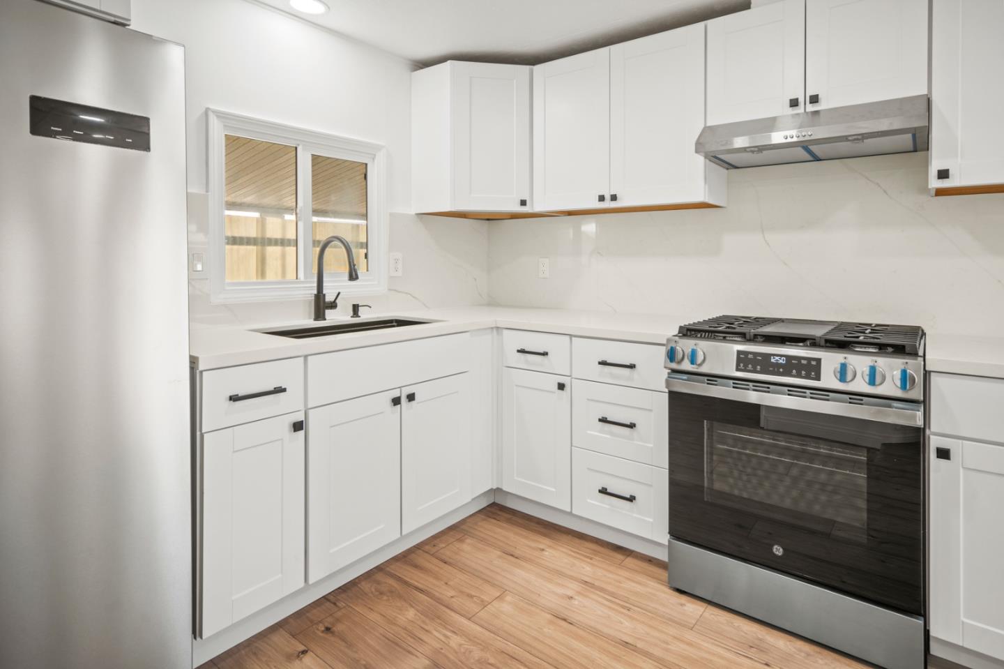 55 San Juan Grade Road, Unit 63 Salinas, CA 93906 - Photo 36 of 37 a kitchen with white cabinets stainless steel appliances and sink