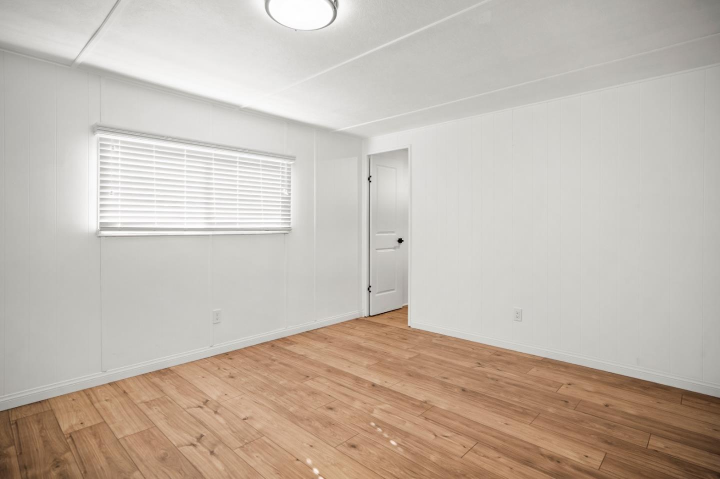 55 San Juan Grade Road, Unit 63 Salinas, CA 93906 - Photo 8 of 37 an empty room with wooden floor and windows