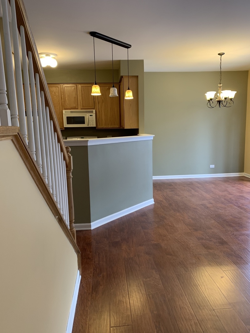 1944 Crestview Circle Romeoville, IL 60446 - Photo 4 of 35 a view of a hallway with wooden floor