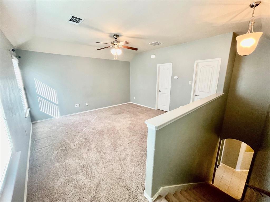 1005 Lake Woodland Drive Little Elm, TX 75068 - Photo 12 of 37 Carpeted spare room with baseboards and a ceiling fan