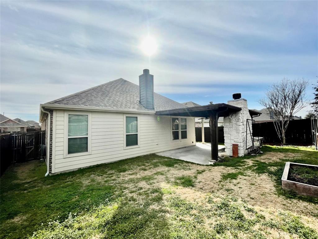 1005 Lake Woodland Drive Little Elm, TX 75068 - Photo 15 of 37 Rear view of property with a patio, a fenced backyard, a chimney, and a shingled roof